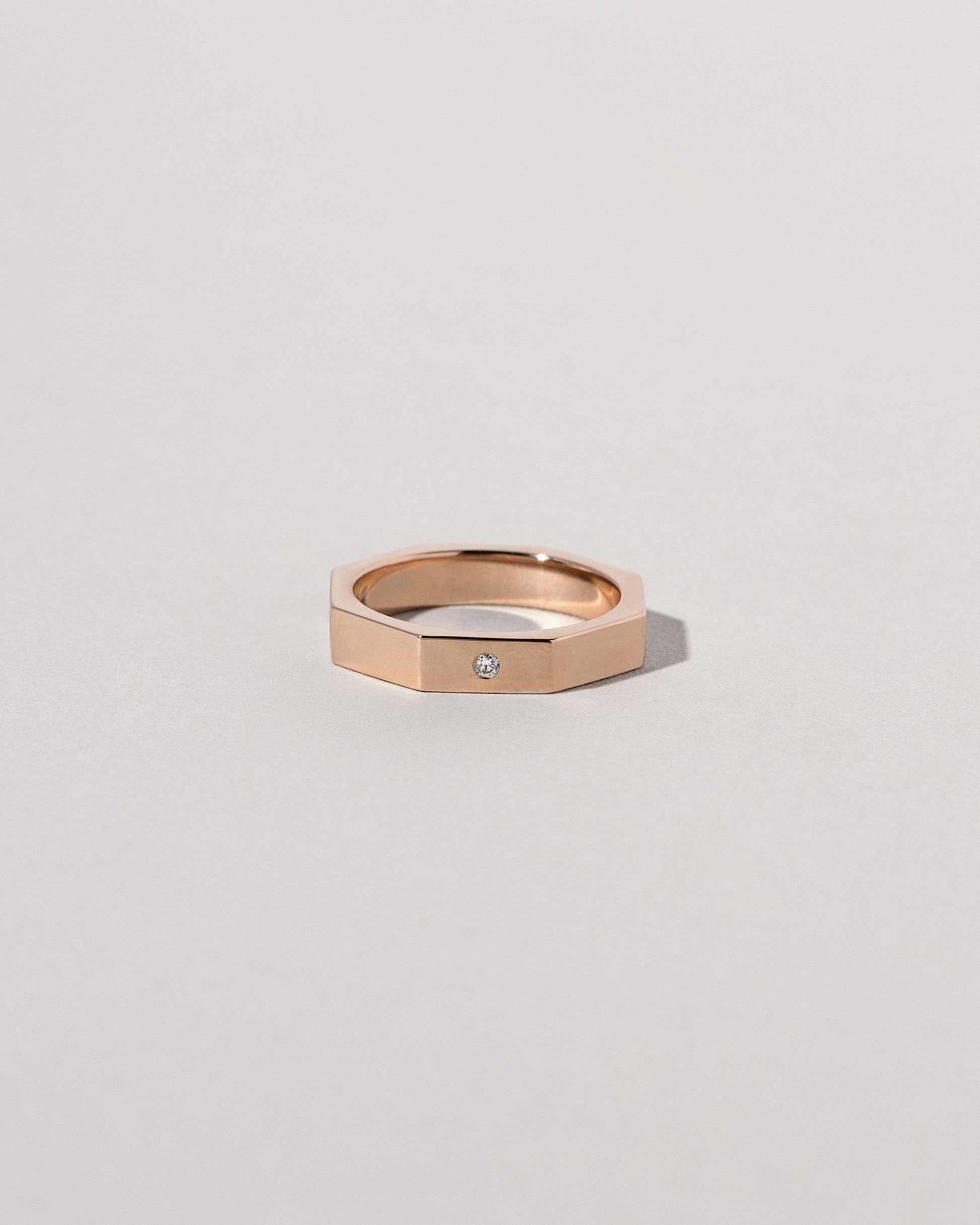 Rose Gold 4mm Single Stone Segmented Band on light color background.