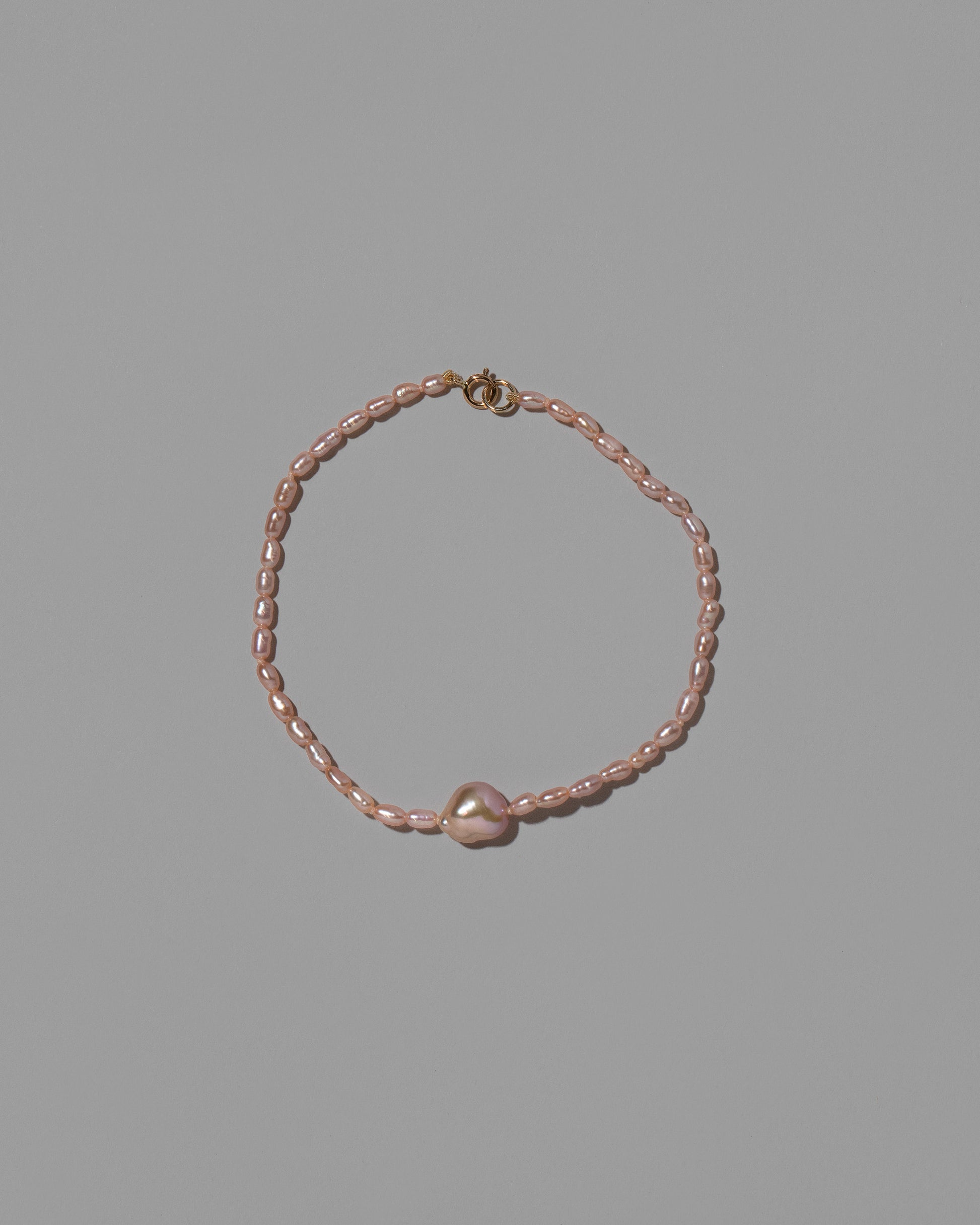 Delphin Pink Lagniappe Bracelet on light color background.