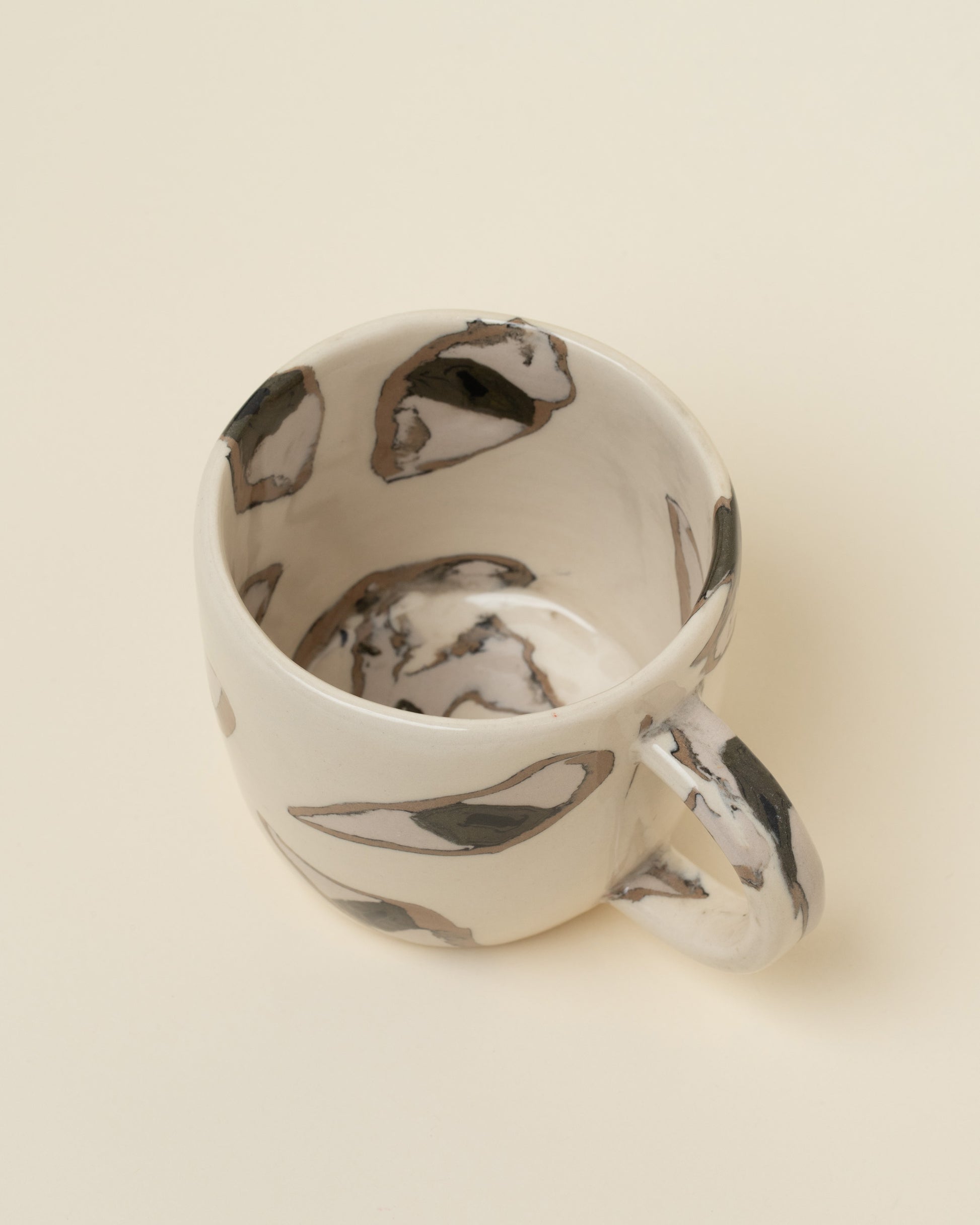 Closeup details of the Slush Club Nerikomi Eye Mug on light color background.