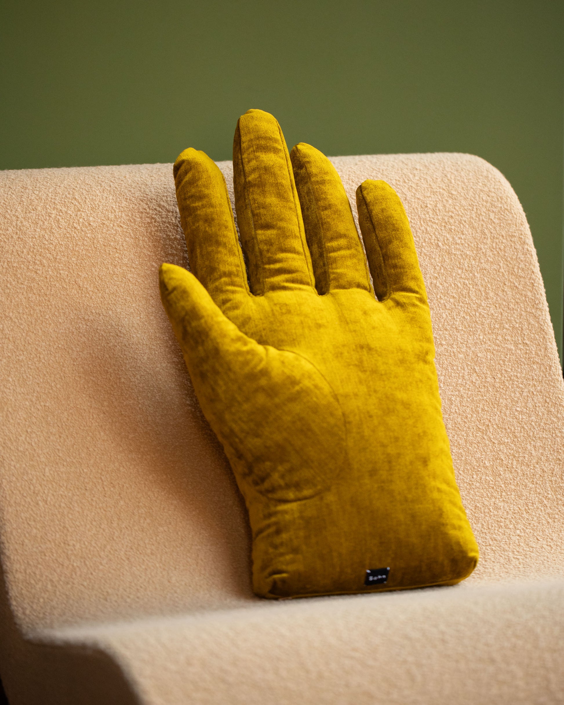 Styled image featuring the Sohn Left Chartreuse Chenille Soft Sculpture Hand Pillow.