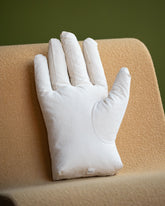 Styled image featuring the Sohn Right Cotton Canvas Soft Sculpture Hand Pillow.