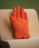 Styled image featuring the Sohn Left Persimmon Chenille Soft Sculpture Hand Pillow.