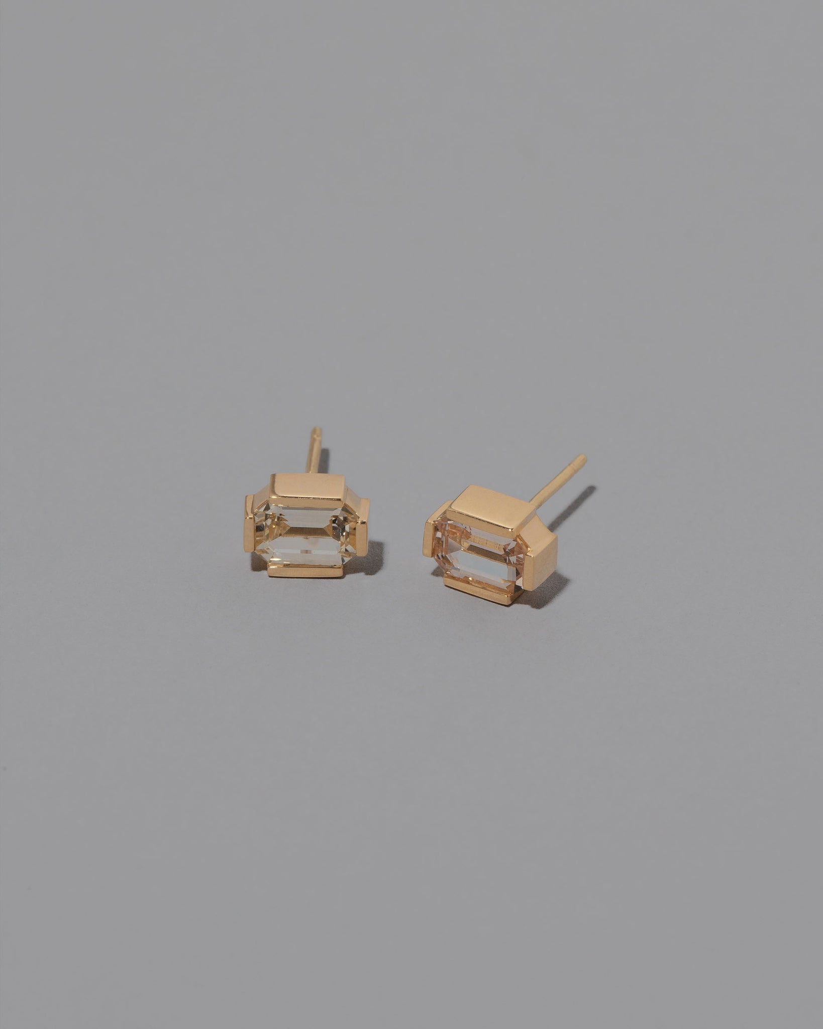 Envelop Earrings on grey color background.