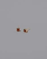 Grand Anthill Garnet Square Frame Stud Earrings on light color background.