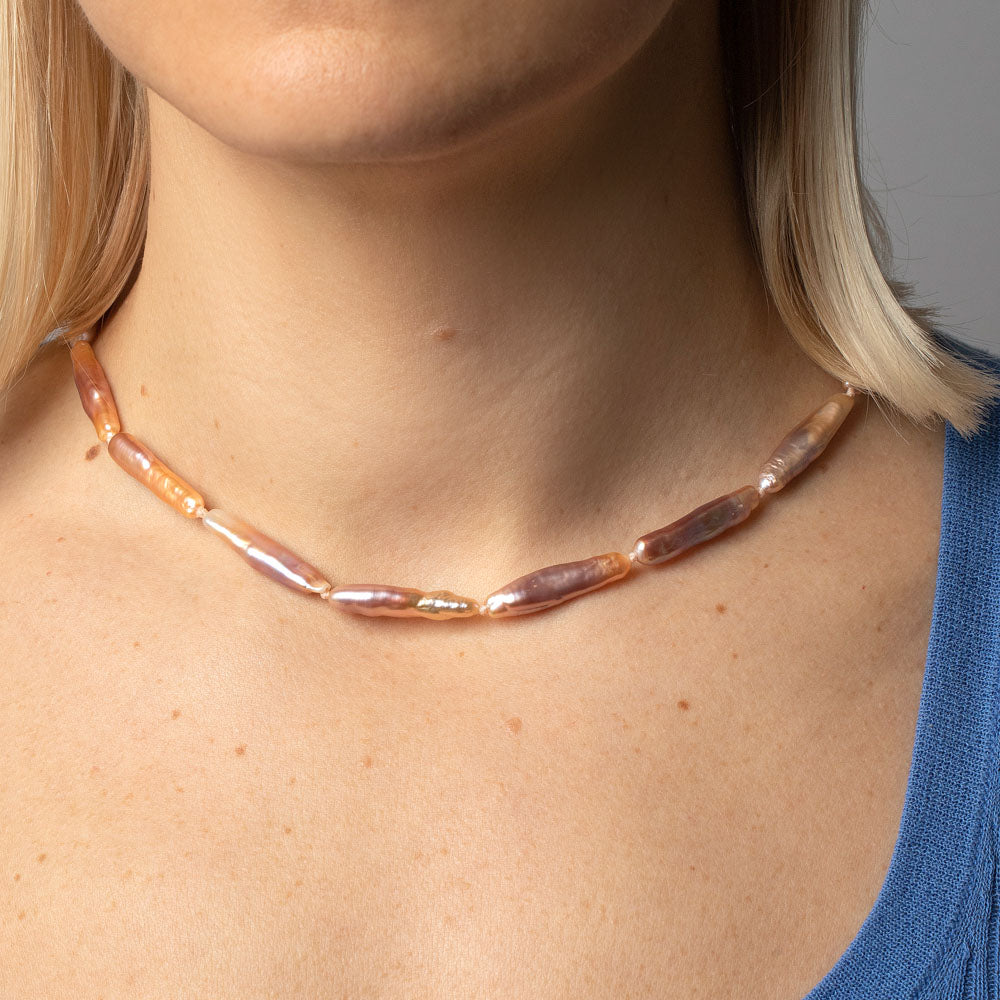 product_details::Blush Stick Pearl Strand Necklace on model.
