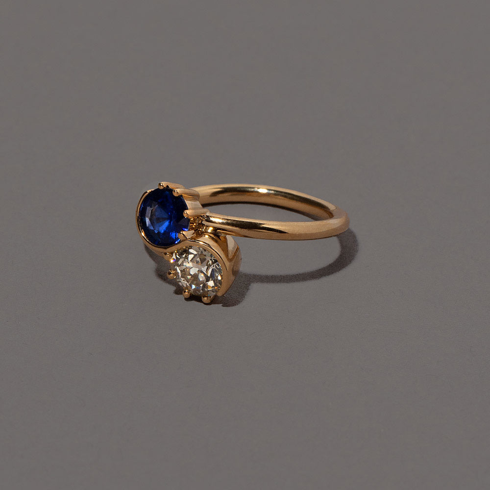 product_details::Closeup details of the Sapphire Sun & Moon Union Ring on light color background.