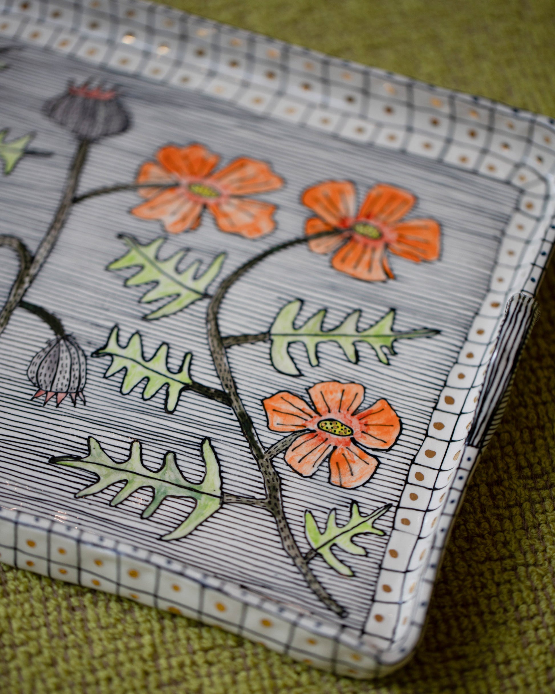 Closeup details of the Suzanne Sullivan For Your Pleasure Poppy Tray on light color background.