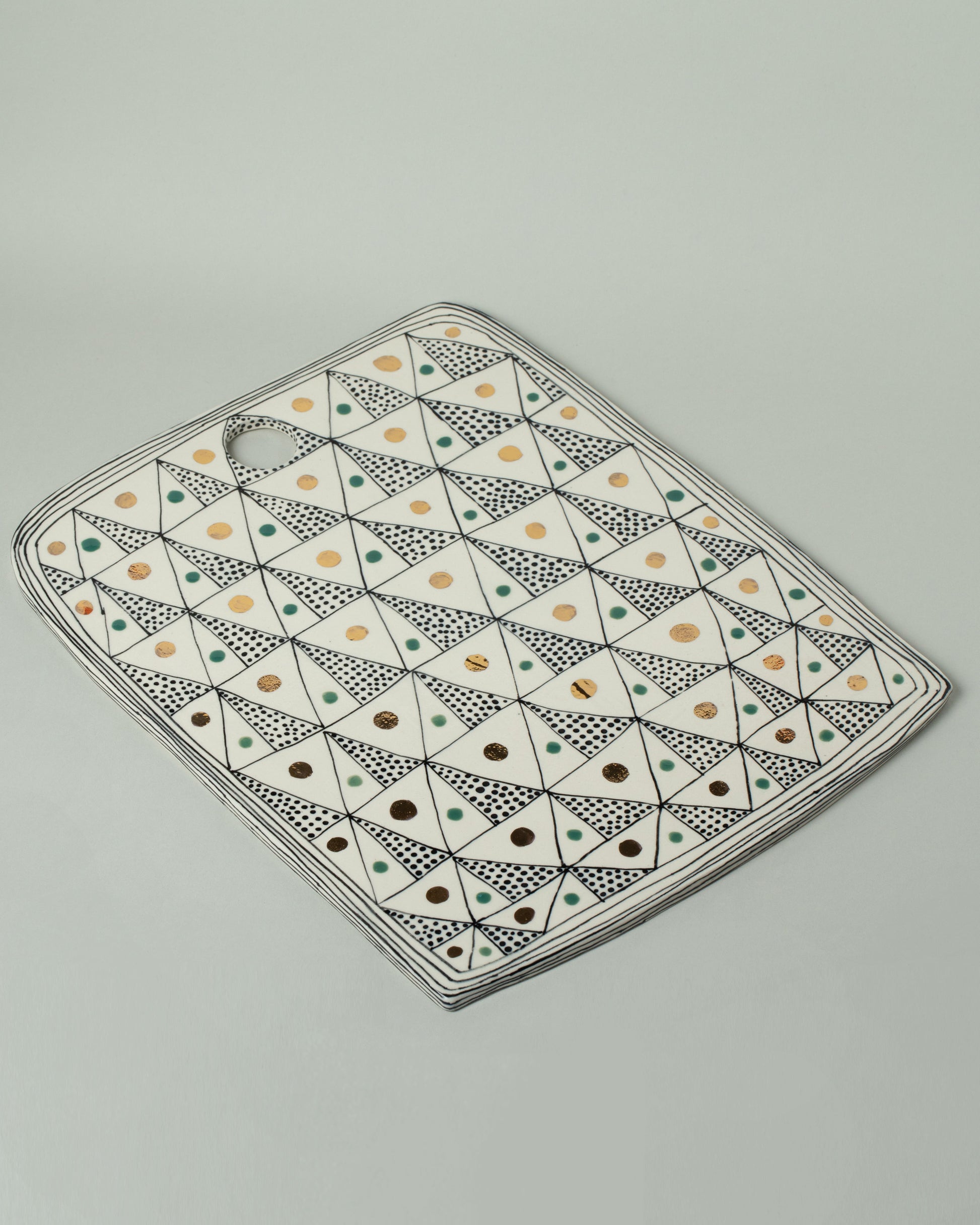 Suzanne Sullivan Three Board on light color background.