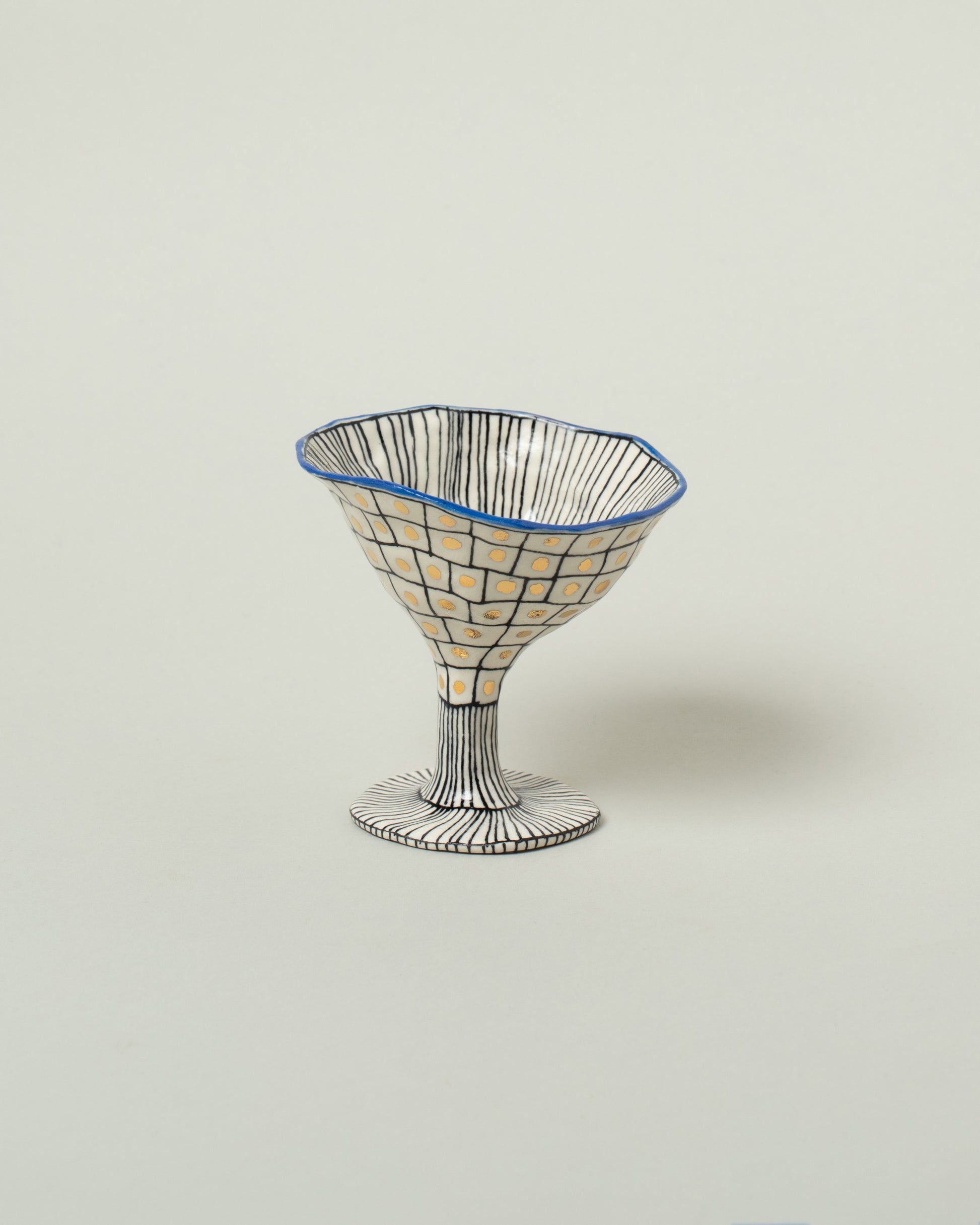 Suzanne Sullivan Cobalt Two For Your Pleasure Martini Glass on light color background.