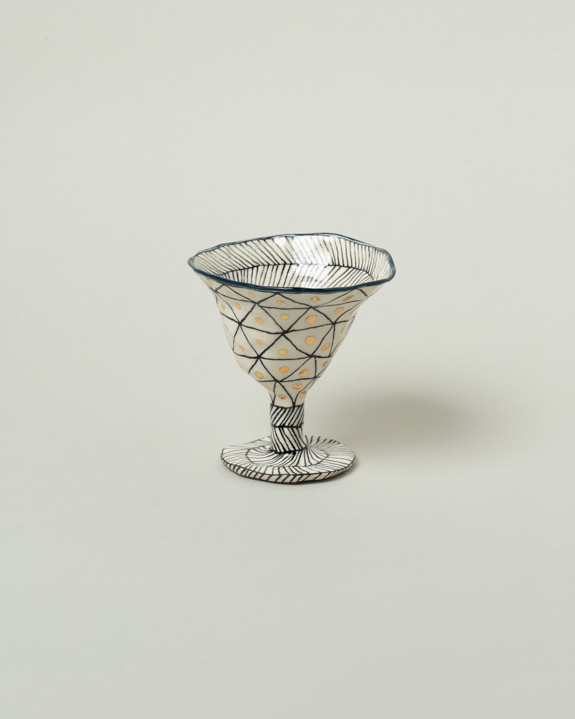 Suzanne Sullivan Midnight Two For Your Pleasure Martini Glass on light color background.