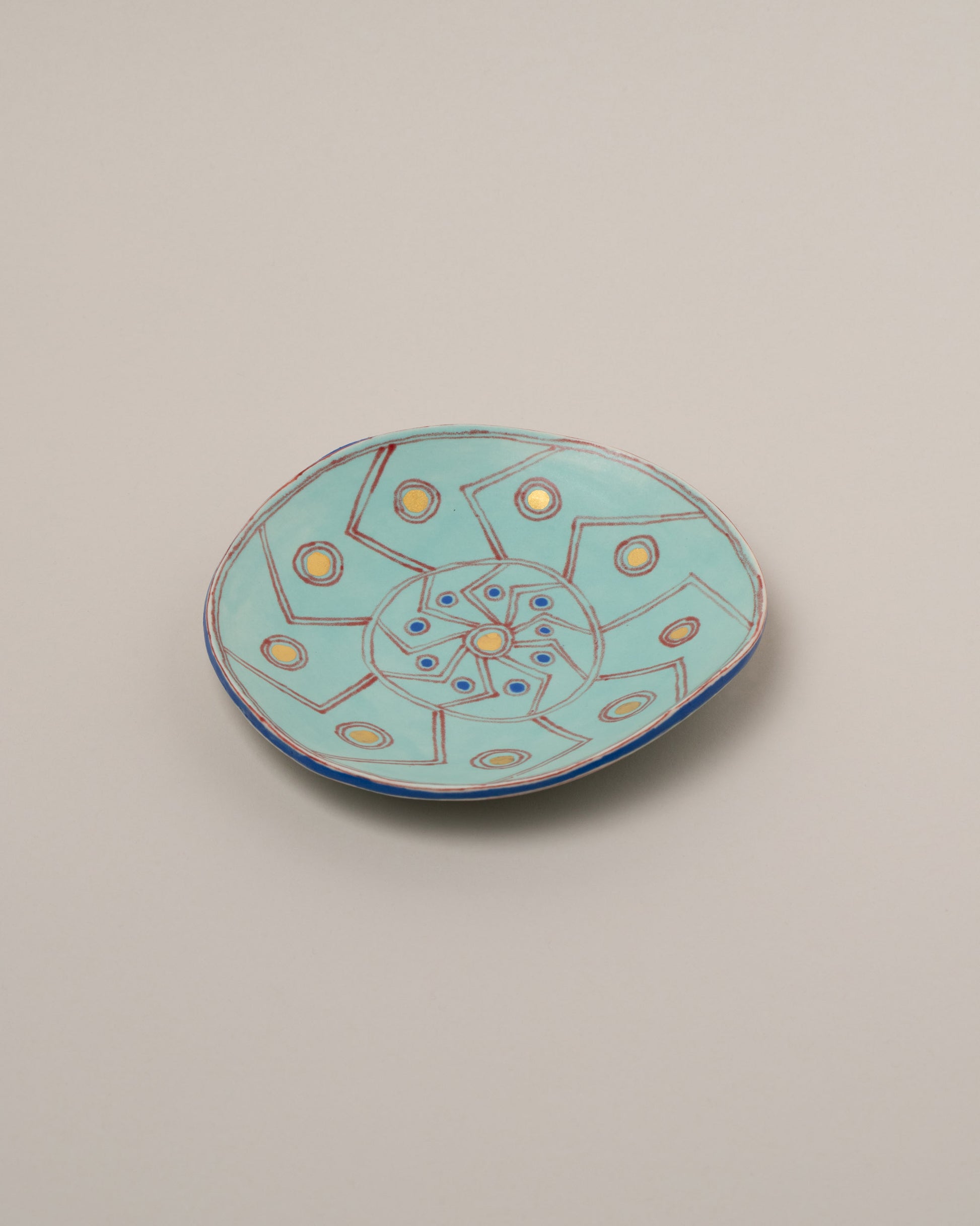 Suzanne Sullivan Two And Lost No Time Small Plate on light color background.