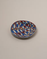 Suzanne Sullivan Three And Lost No Time Small Plate on light color background.