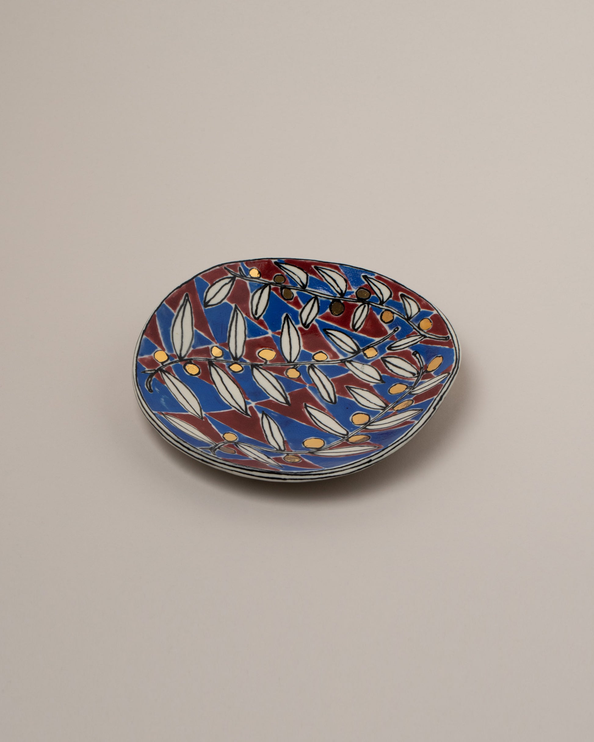 Suzanne Sullivan Three And Lost No Time Small Plate on light color background.