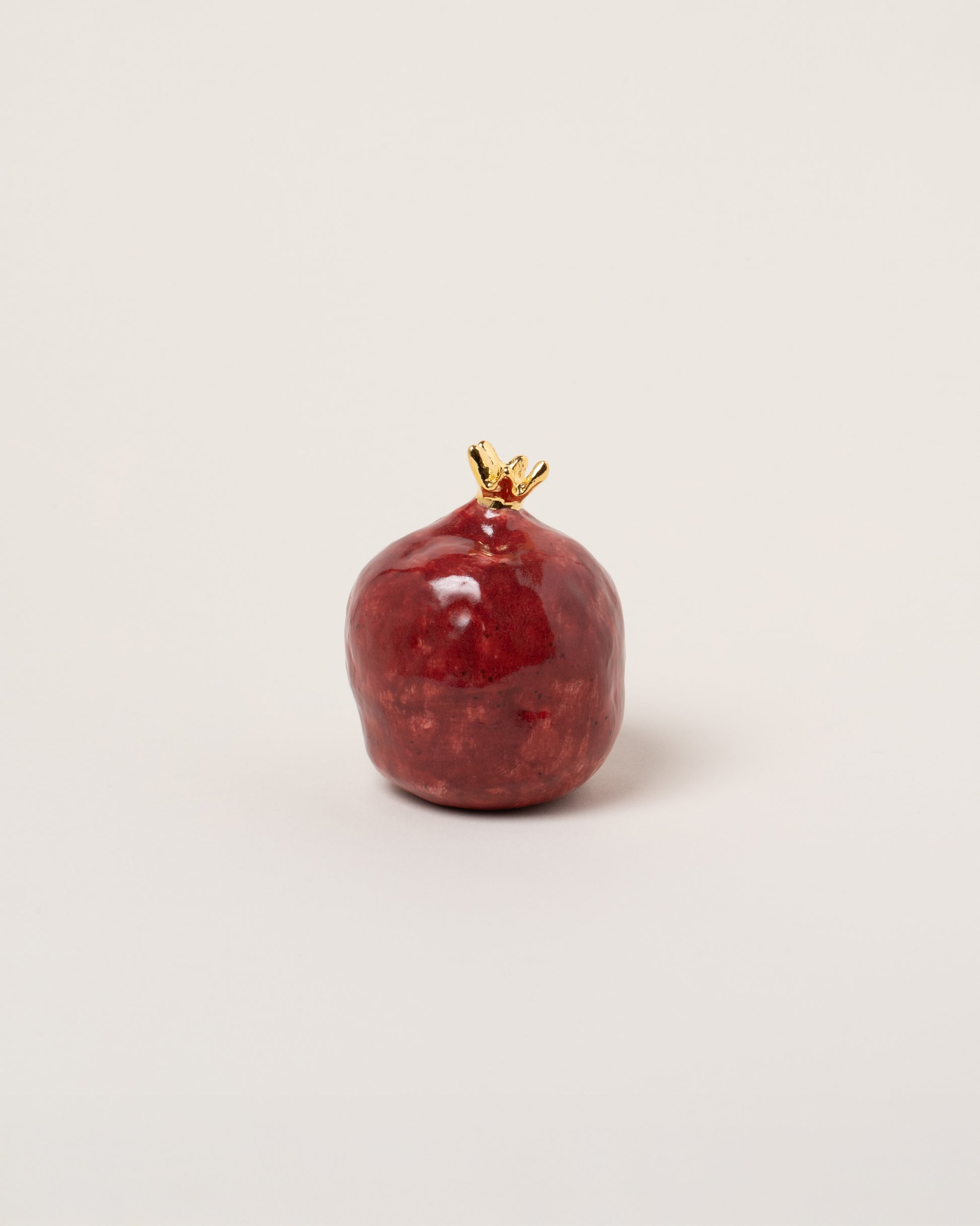 Suzanne Sullivan Pomegranate on light color background.