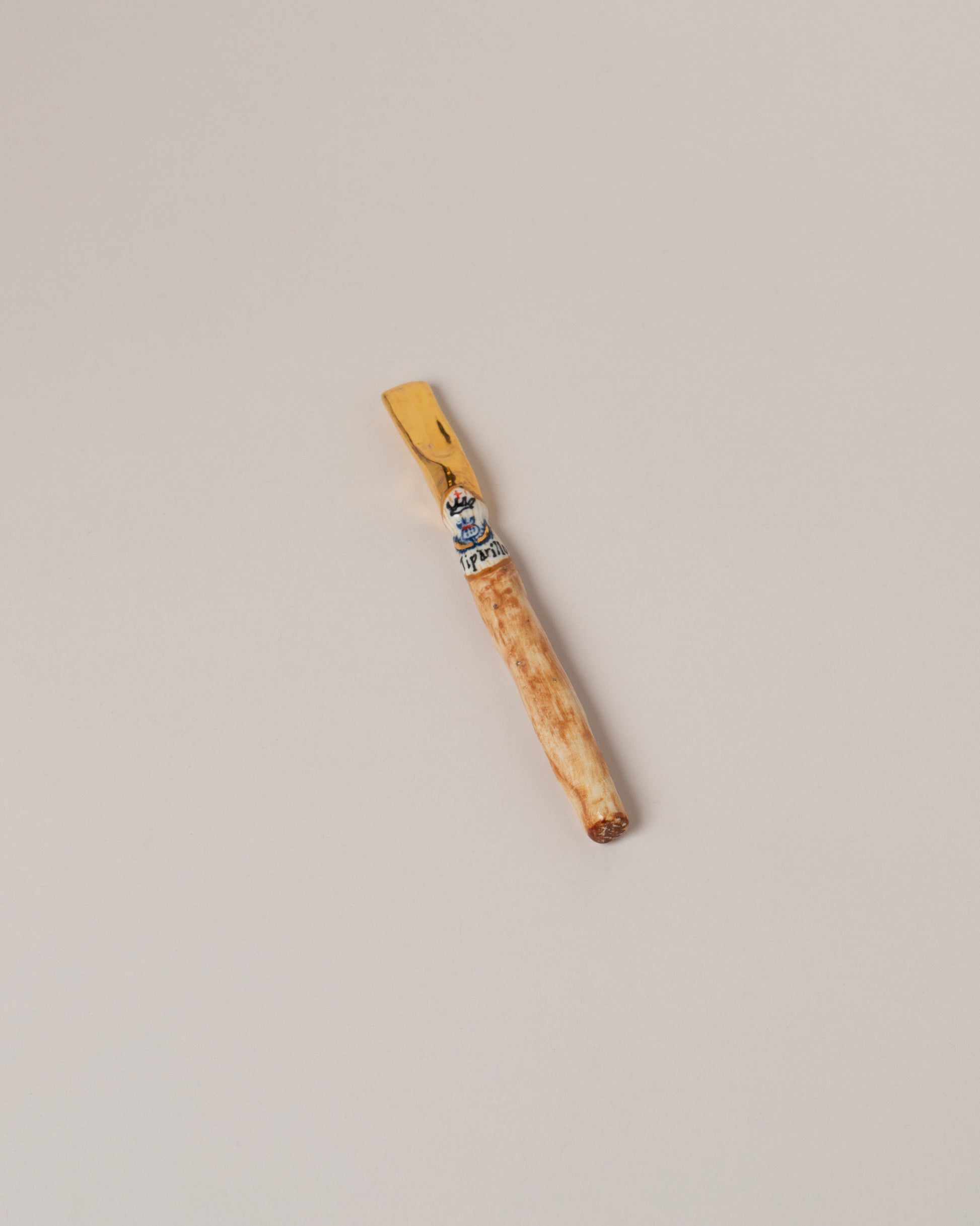 Suzanne Sullivan Tiparillo Cigar on light color background.