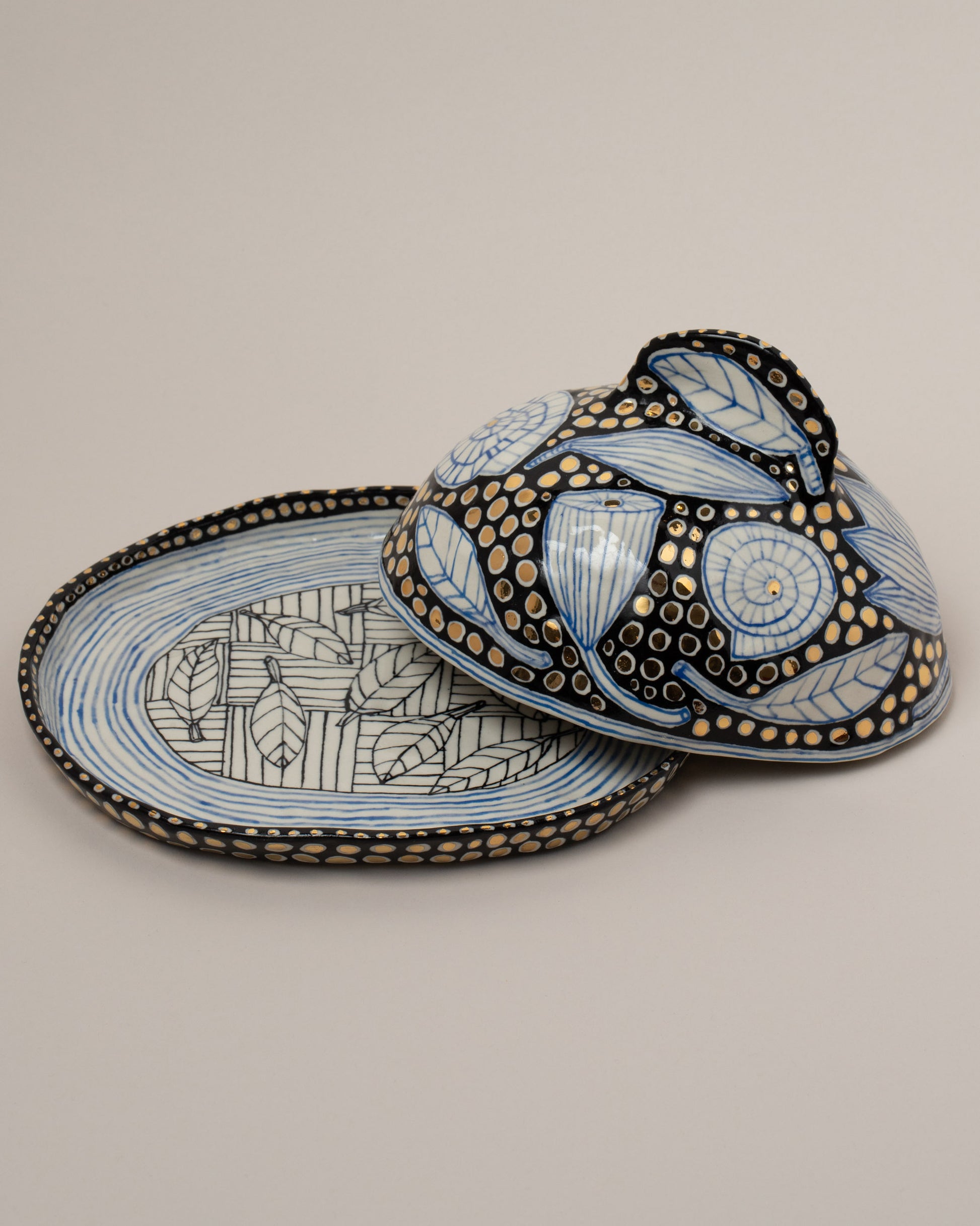 Detail view of the Suzanne Sullivan One Accidental Companionship Butter Dish on light color background.