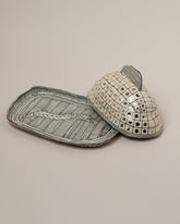 Detail view of the Suzanne Sullivan Two Accidental Companionship Butter Dish on light color background.