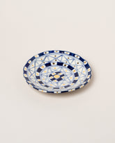 Suzanne Sullivan Five And Lost No Time Small Plate on light color background.