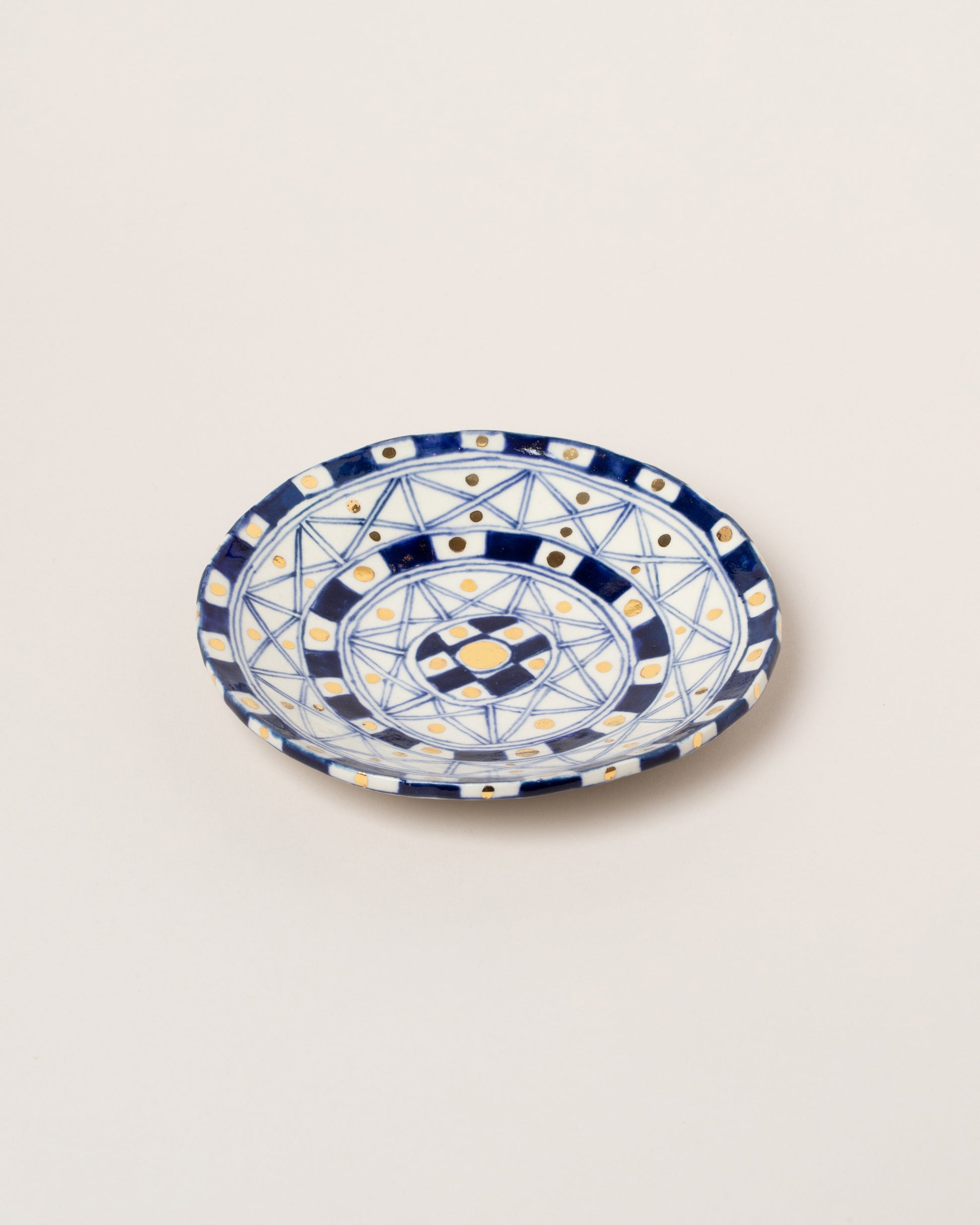 Suzanne Sullivan Five And Lost No Time Small Plate on light color background.