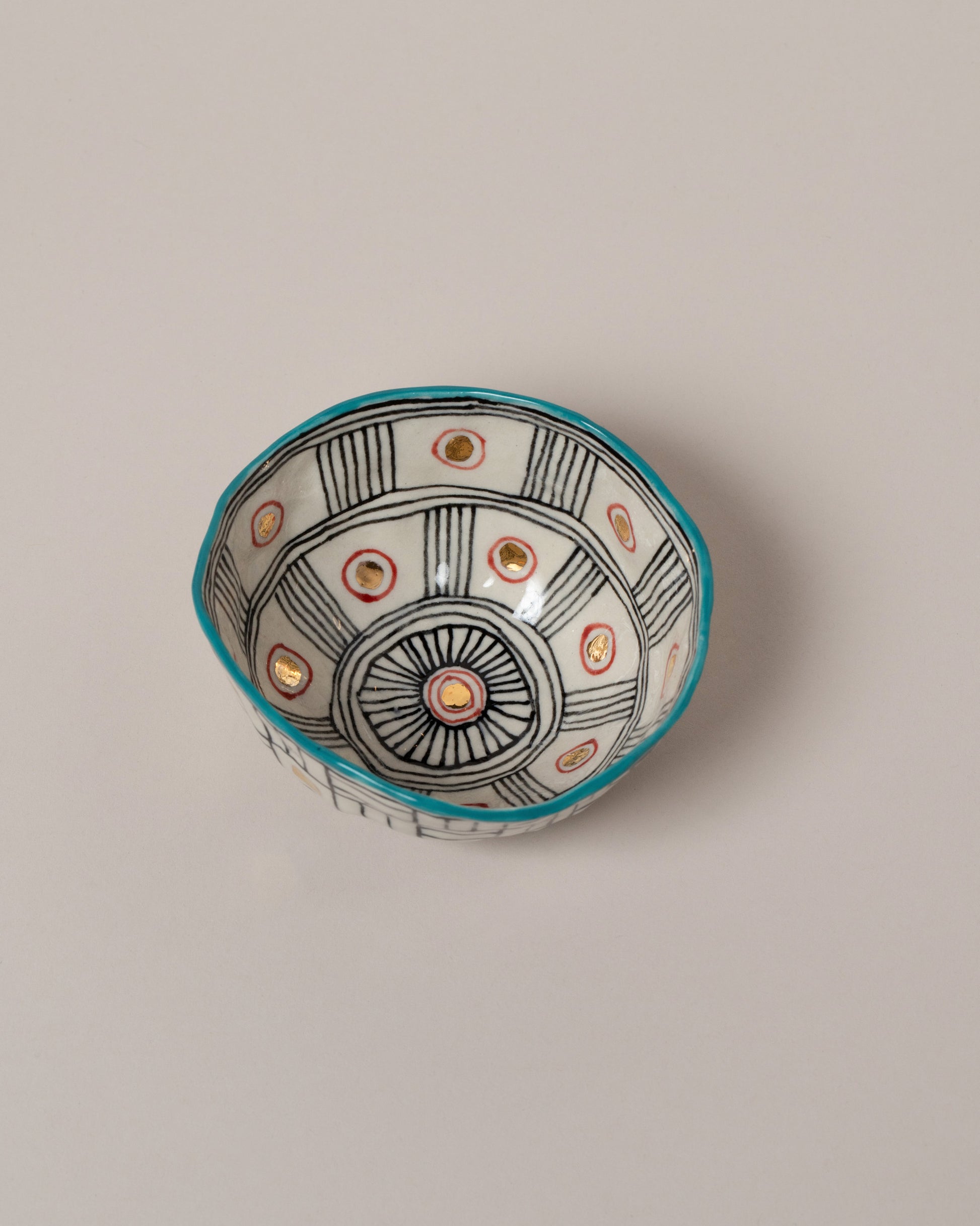 Suzanne Sullivan Six Full Of Deepest Meaning Small Bowl on light color background.