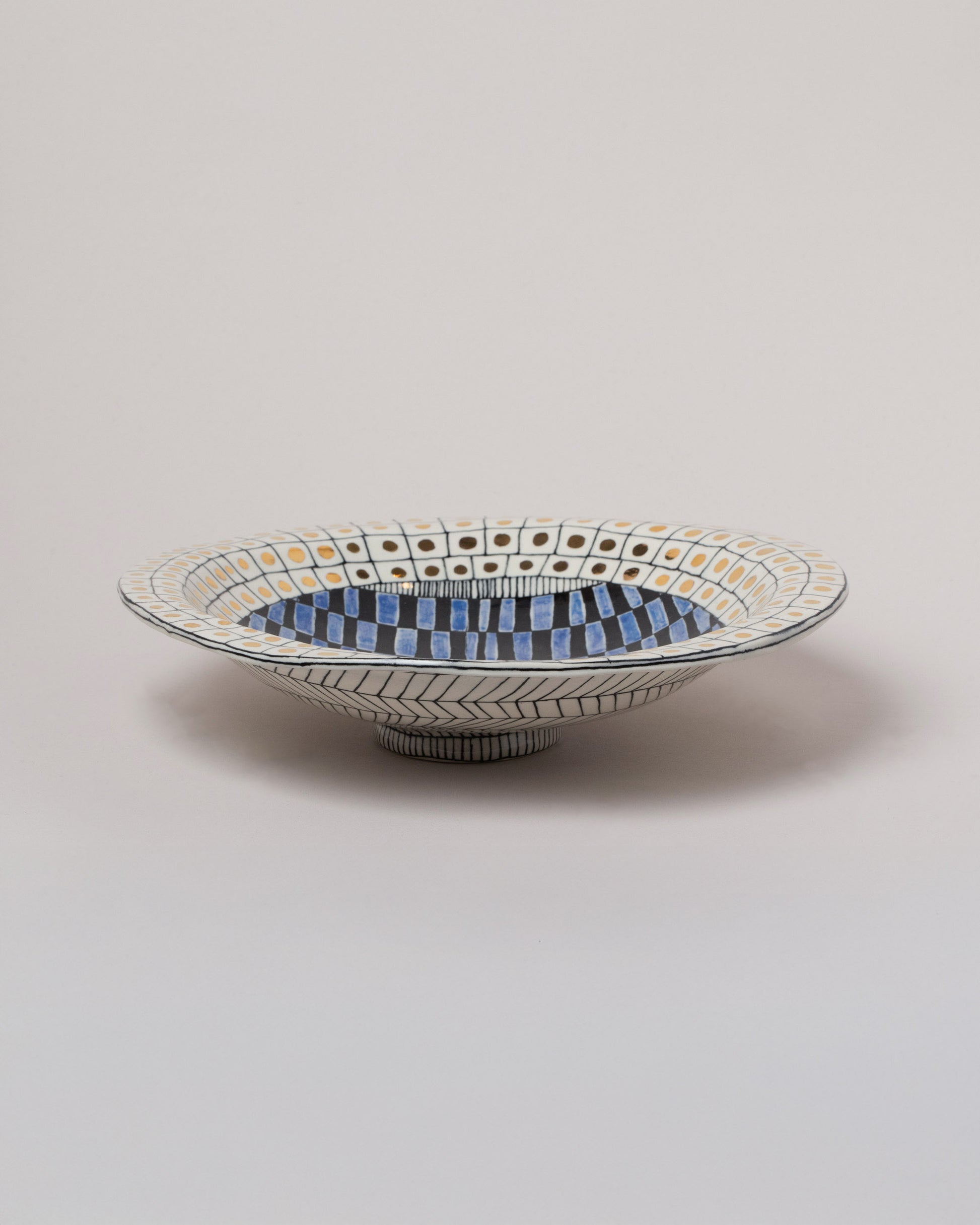 Suzanne Sullivan High Living And Honesty Footed Bowl on light color background.