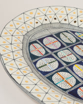 Closeup details of the Suzanne Sullivan Liberal Instrument Of Largesse Platter on light color background.