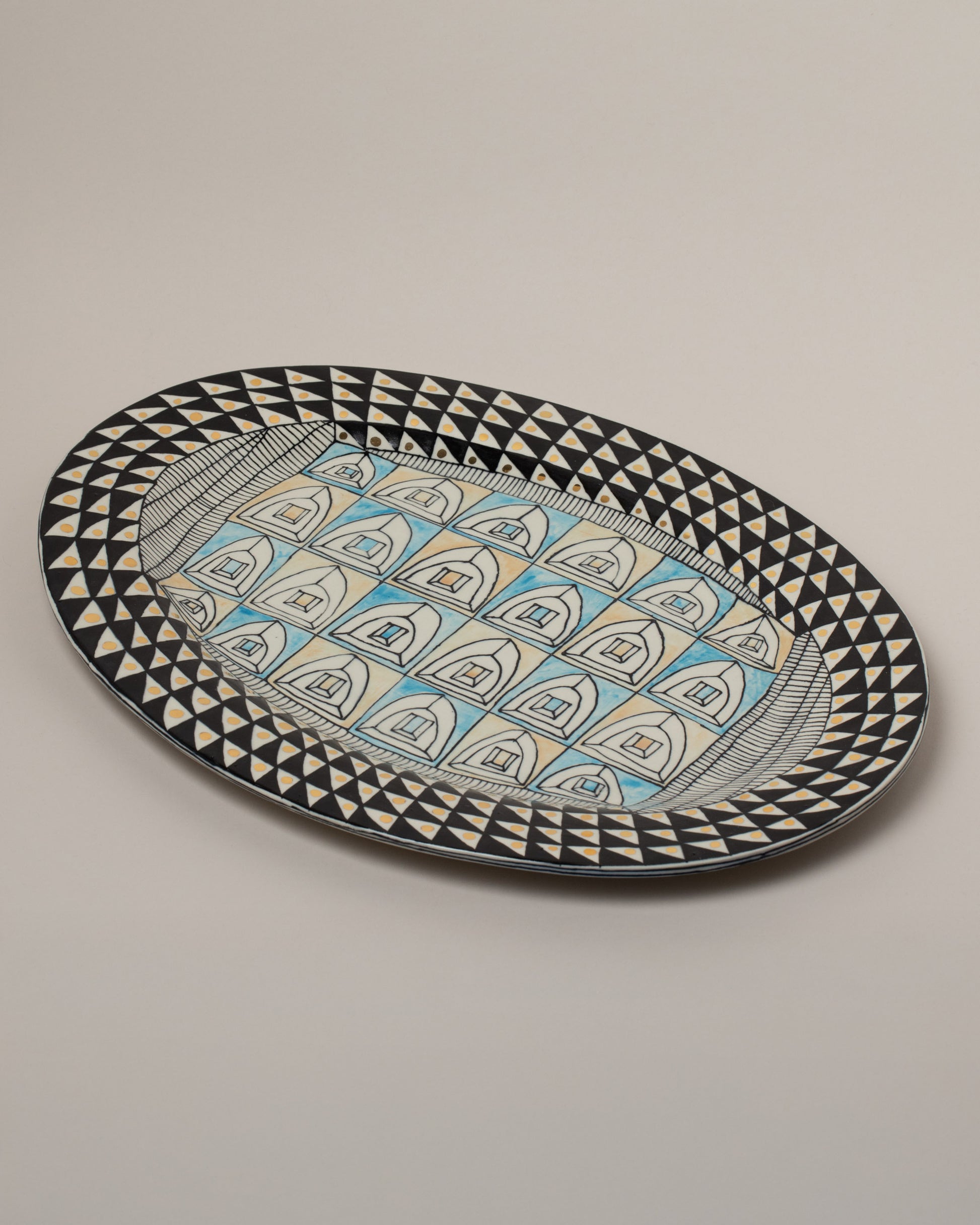 Suzanne Sullivan Rigged Out Stylishly Oval Platter on light color background.