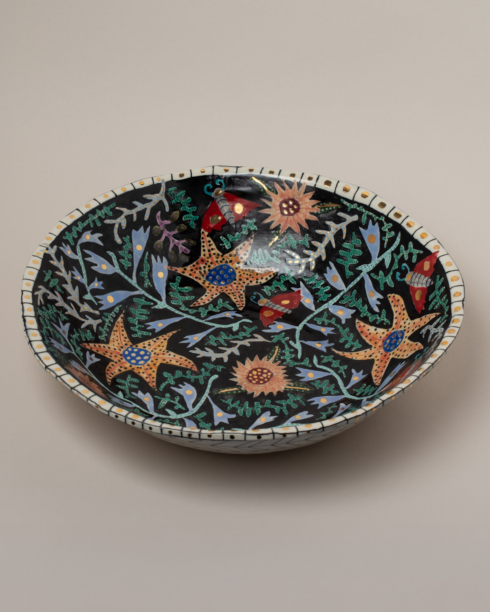 Closeup details of the Suzanne Sullivan So Well & Merrily Serving Bowl on light color background.