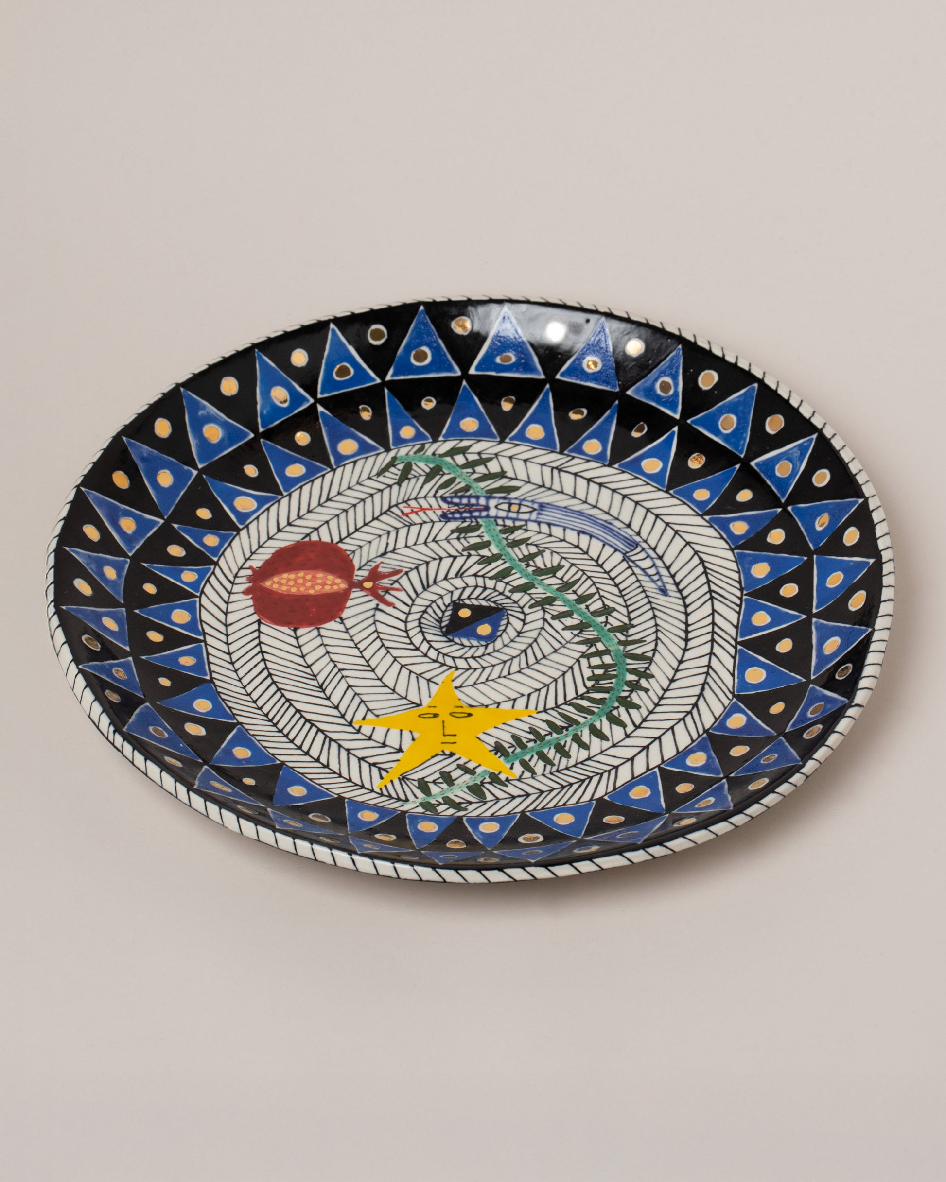 Suzanne Sullivan Tell Another Tale Round Platter on light color background.