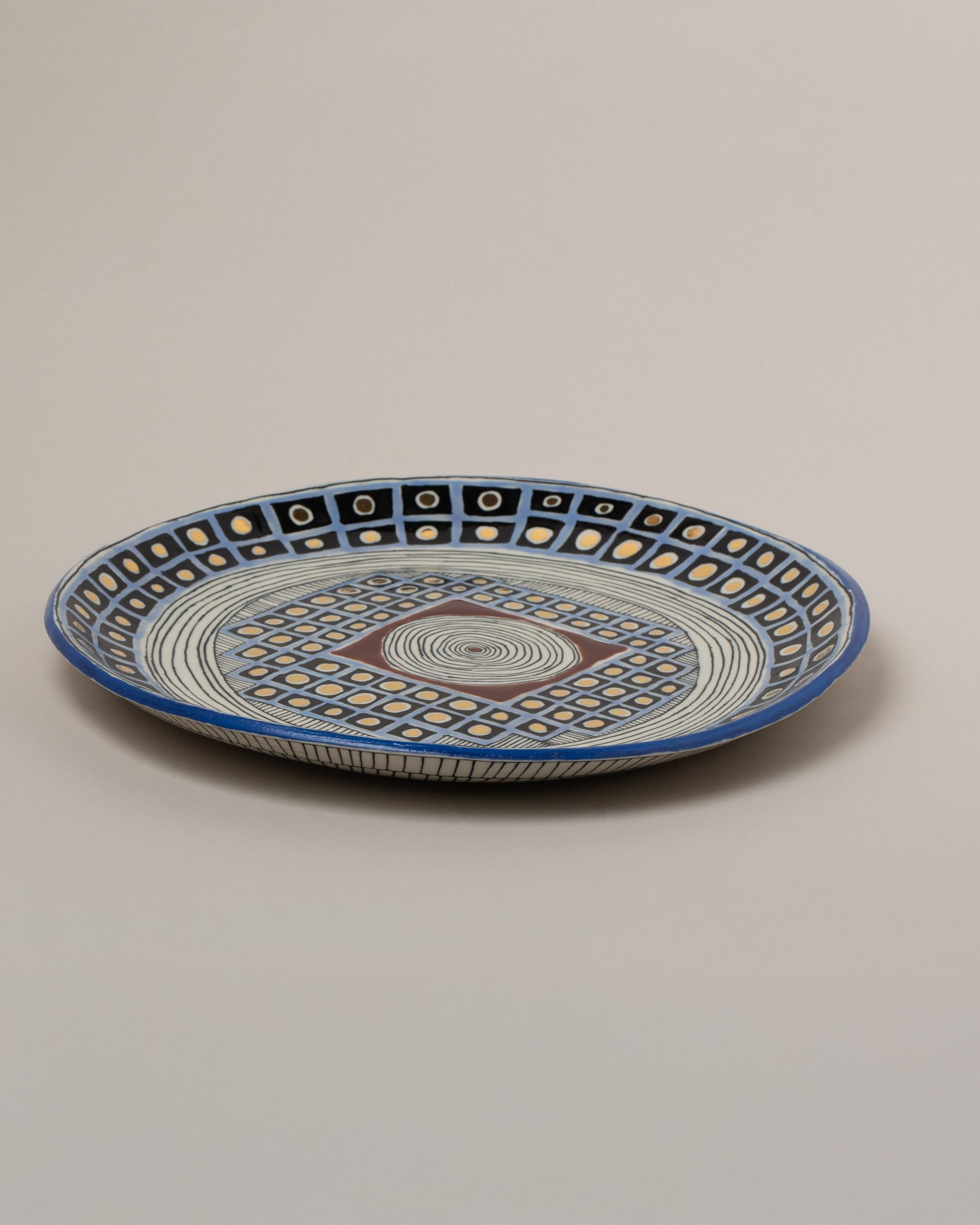 Suzanne Sullivan Well Deserving Of Esteem Round Platter on light color background.