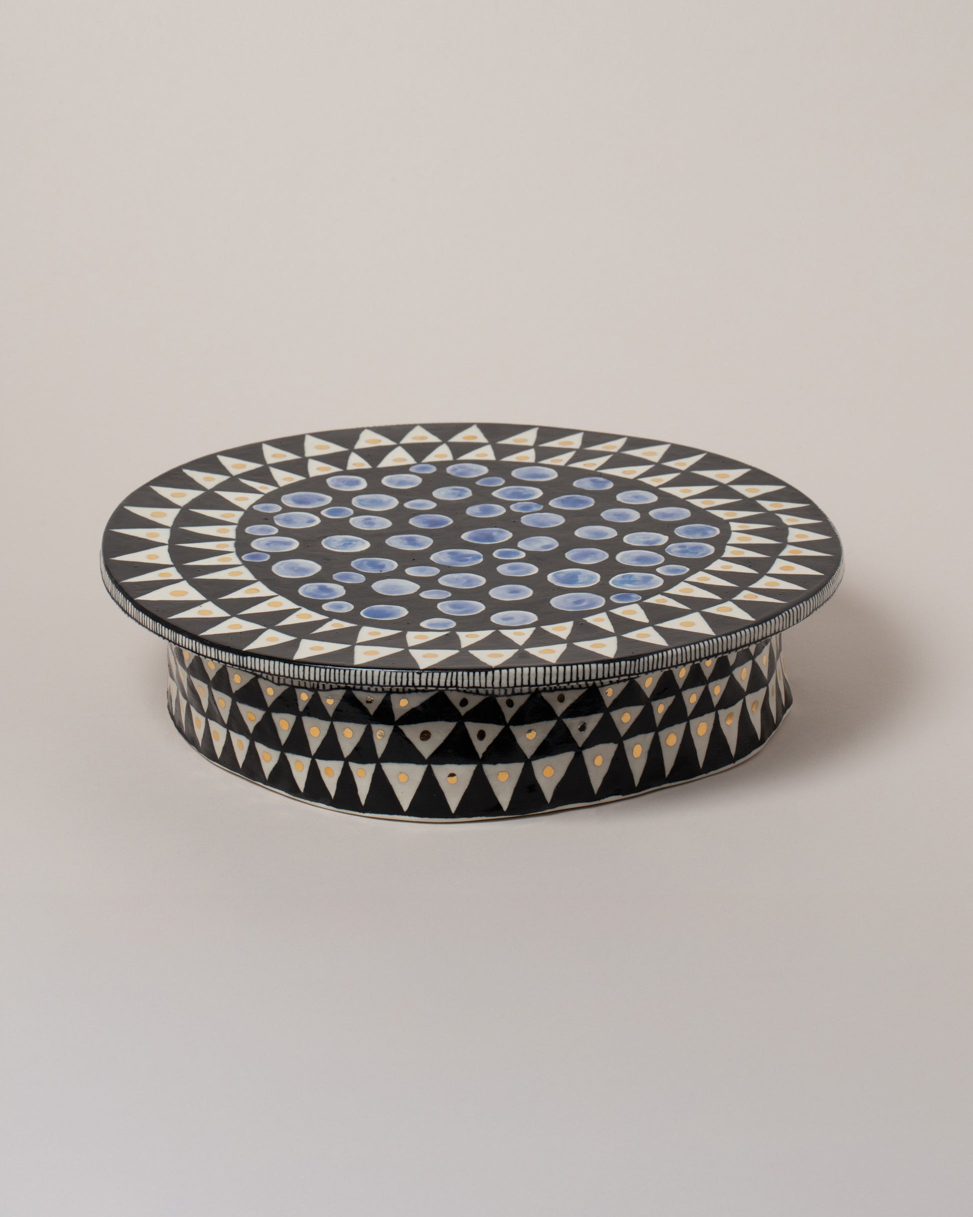 Suzanne Sullivan You'll Have To Distort It Cake Stand on light color background.