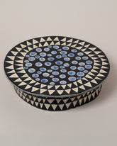 Closeup details of the Suzanne Sullivan You'll Have To Distort It Cake Stand on light color background.