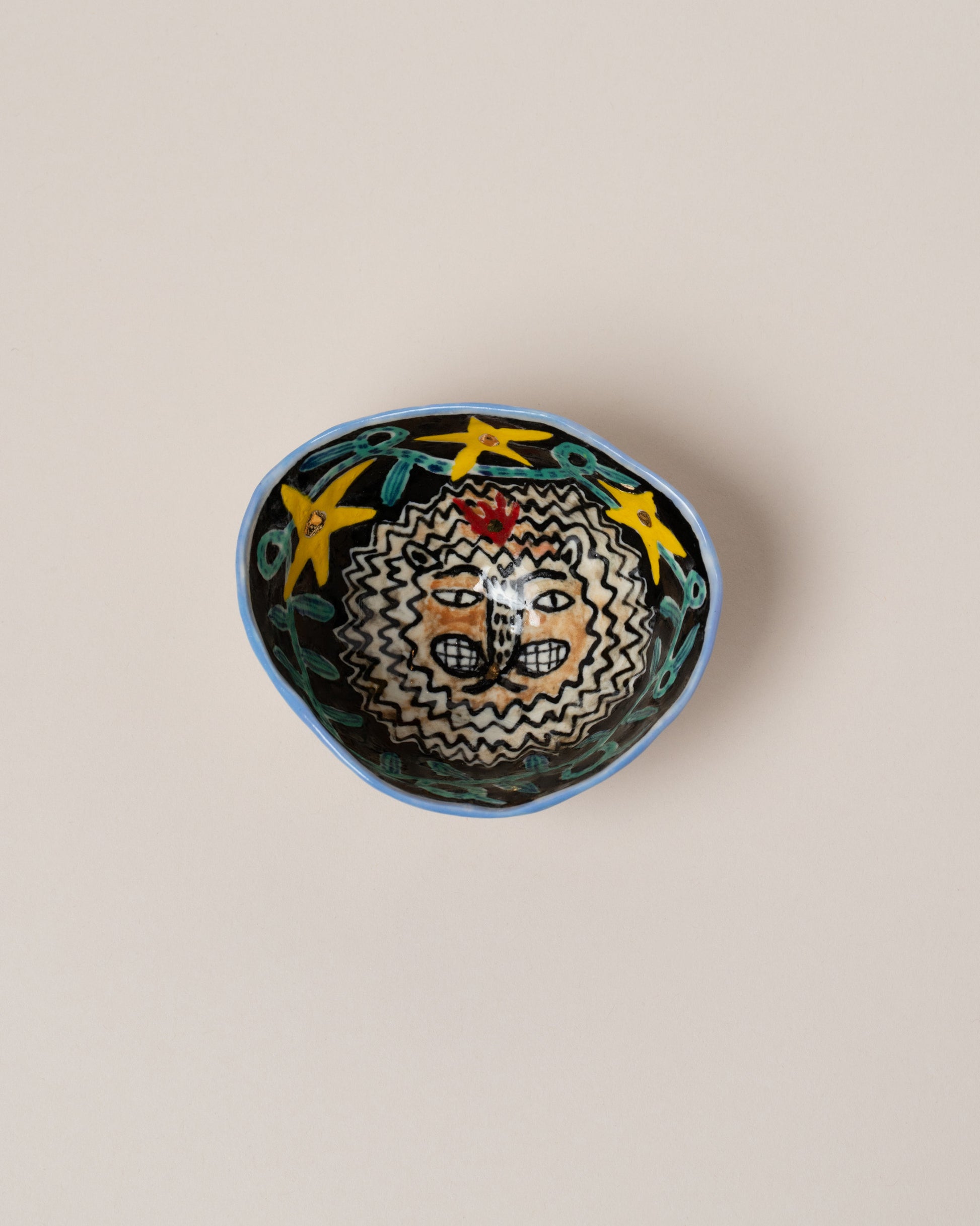 Suzanne Sullivan Leo Zodiac Sign Small Bowl on light color background.