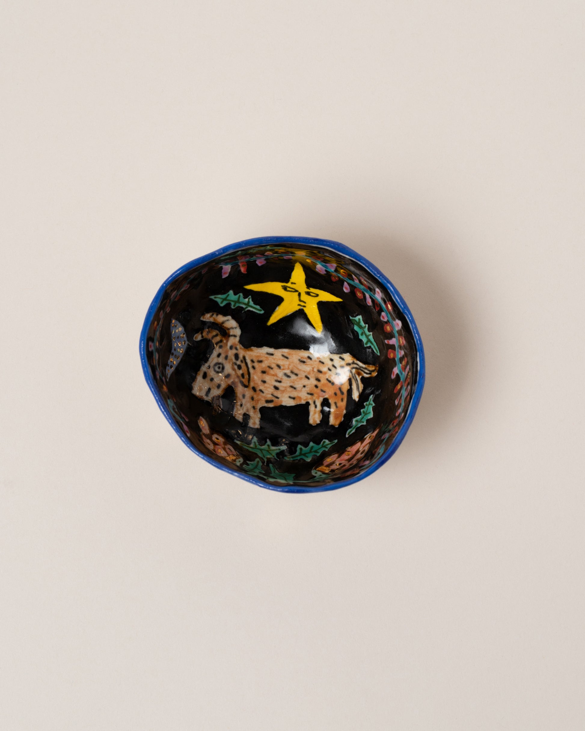 Suzanne Sullivan Capricorn Zodiac Sign Small Bowl on light color background.