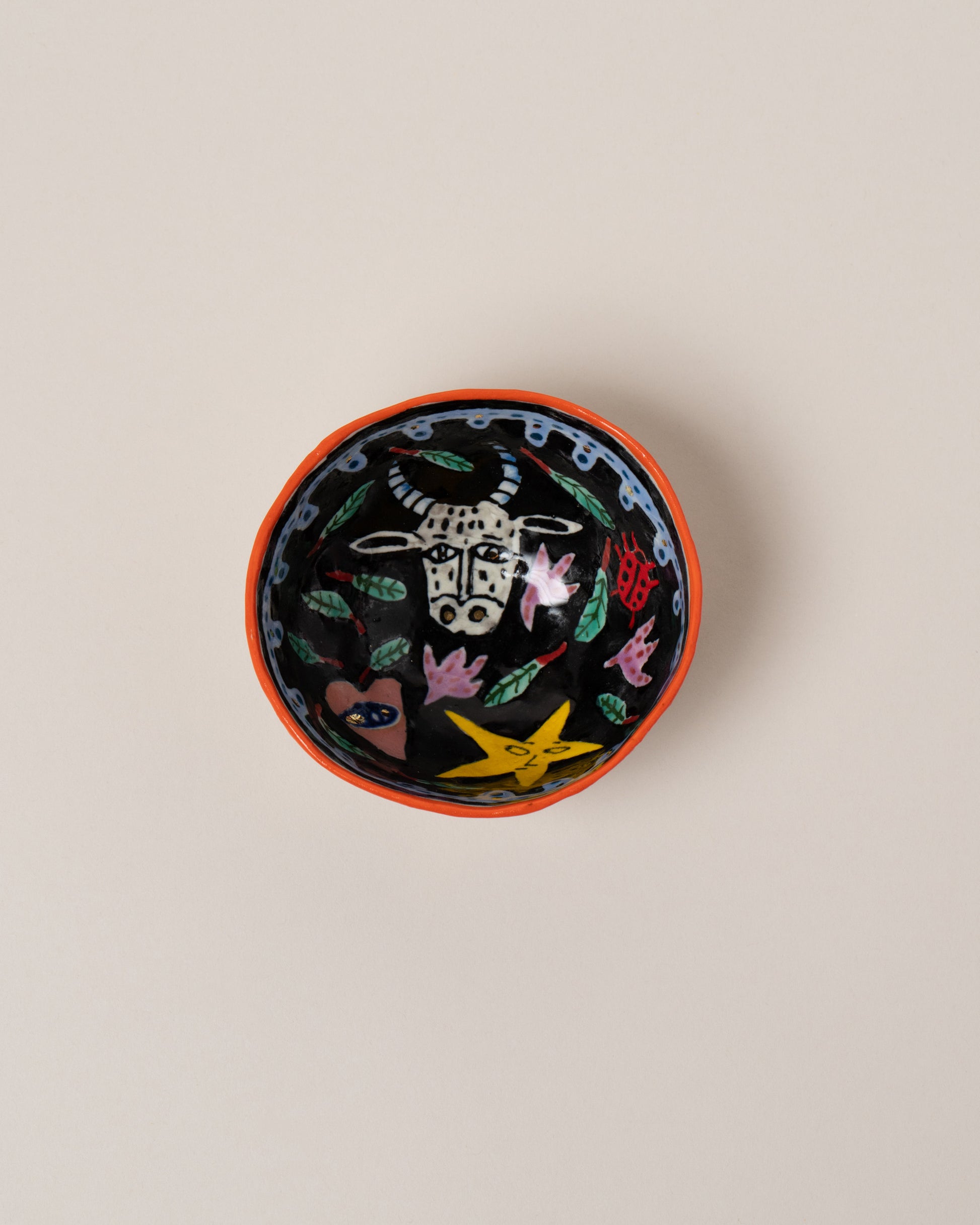 Suzanne Sullivan Taurus Zodiac Sign Small Bowl on light color background.