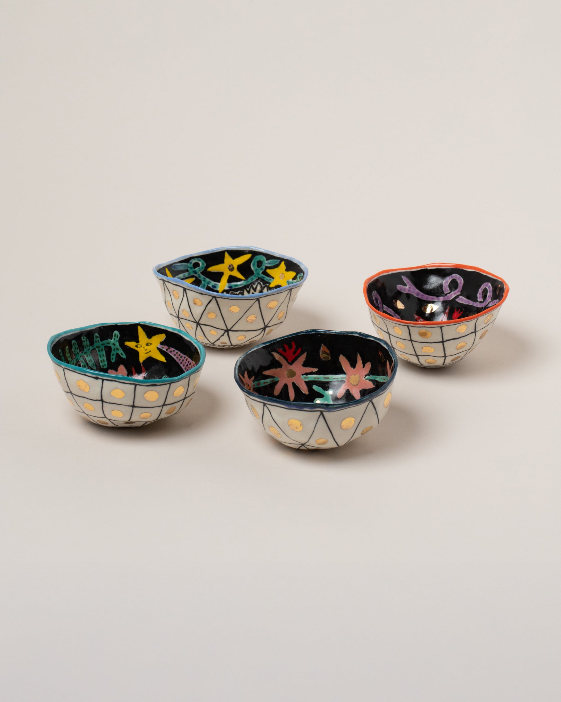 Suzanne Sullivan Zodiac Sign Small Bowls on light color background.