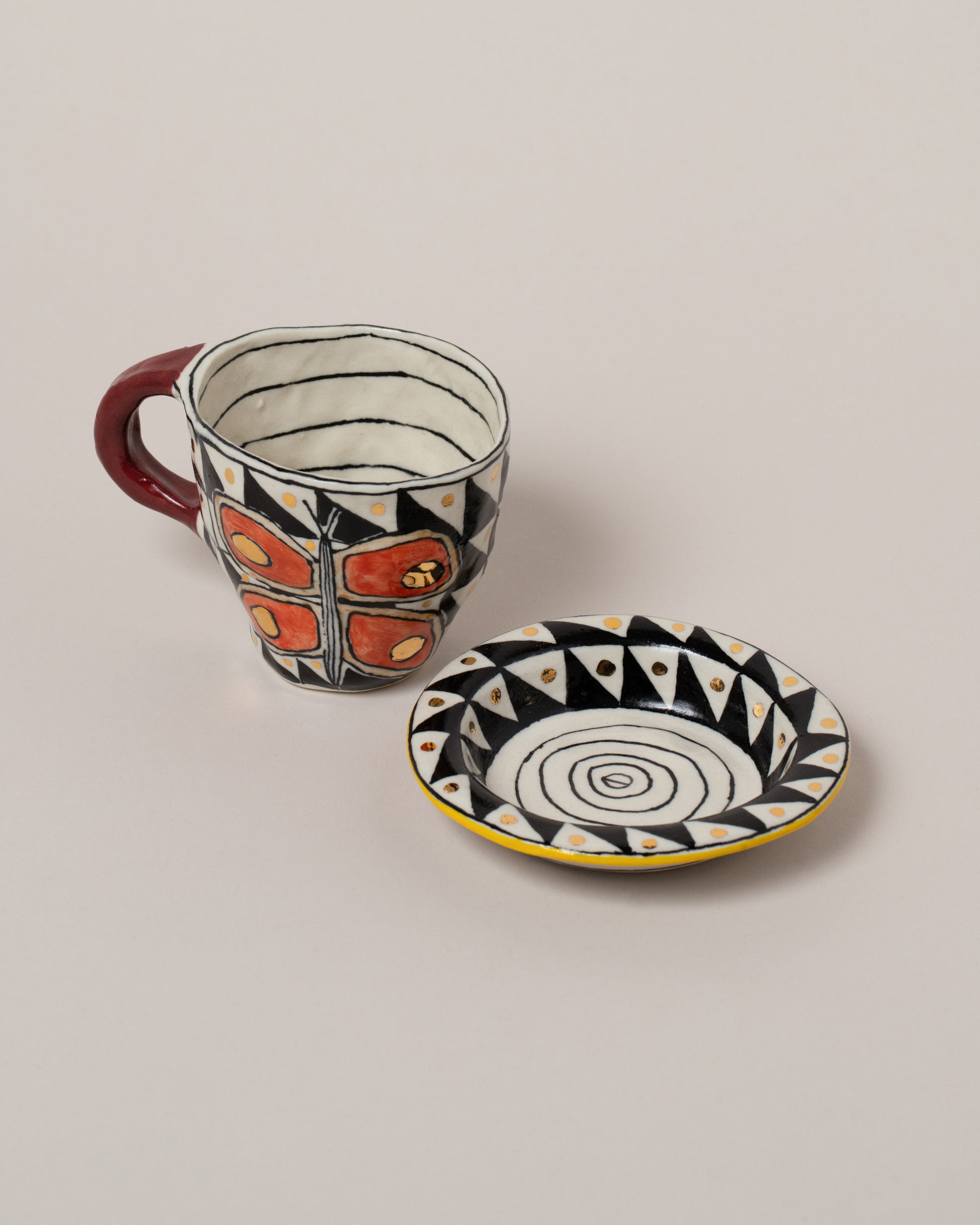 Suzanne Sullivan Three A Long Story Short Espresso Cup & Saucer on light color background.
