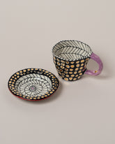 Suzanne Sullivan Five A Long Story Short Espresso Cup & Saucer on light color background.