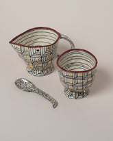 Closeup details of the Suzanne Sullivan Captured The Imagination Sugar & Creamer Set With Spoon on light color background.