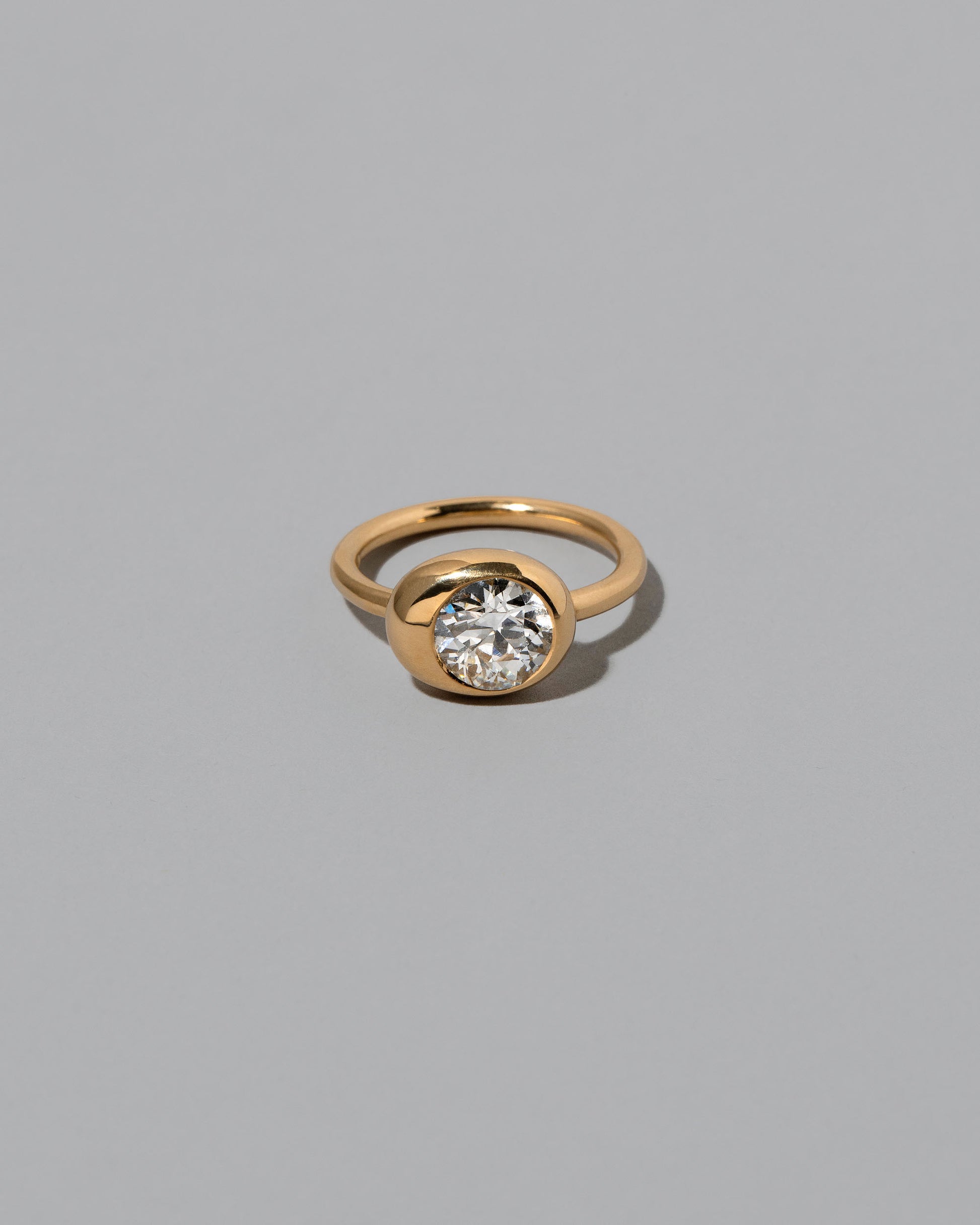 White Diamond Grand Level Ring on light color background.