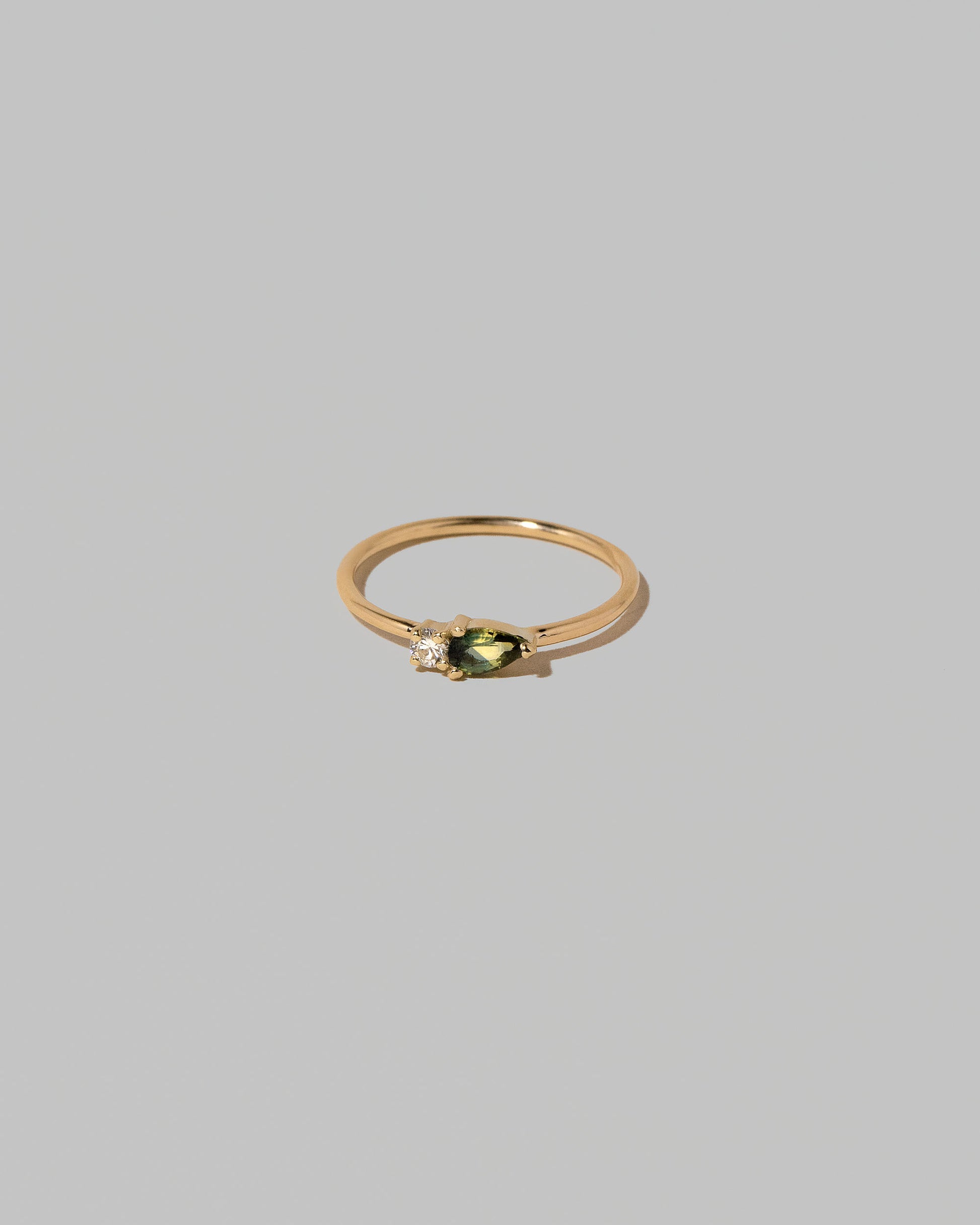 Bicolor Sapphire Teardrops Ring on light color background.
