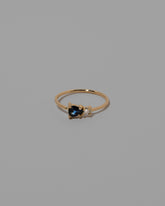 Blue Green Sapphire Teardrop Ring on light color background.