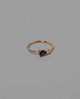 View from the side of the Blue Green Sapphire Teardrop Ring on light color background.