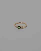 Green Sapphire Teardrop Ring on light color background.