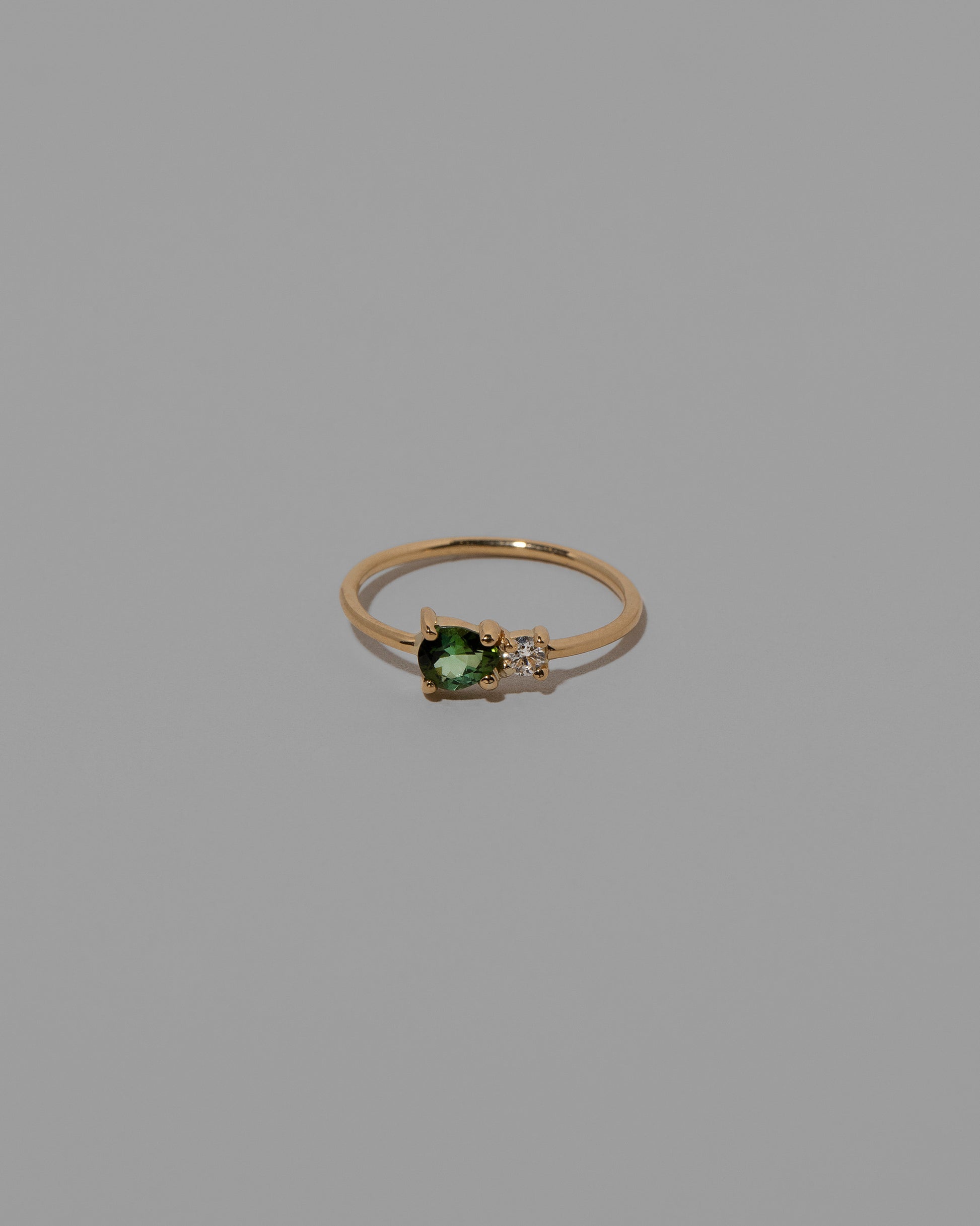 Green Sapphire Teardrop Ring on light color background.