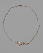 Tethys Pearl Necklace on light color background.