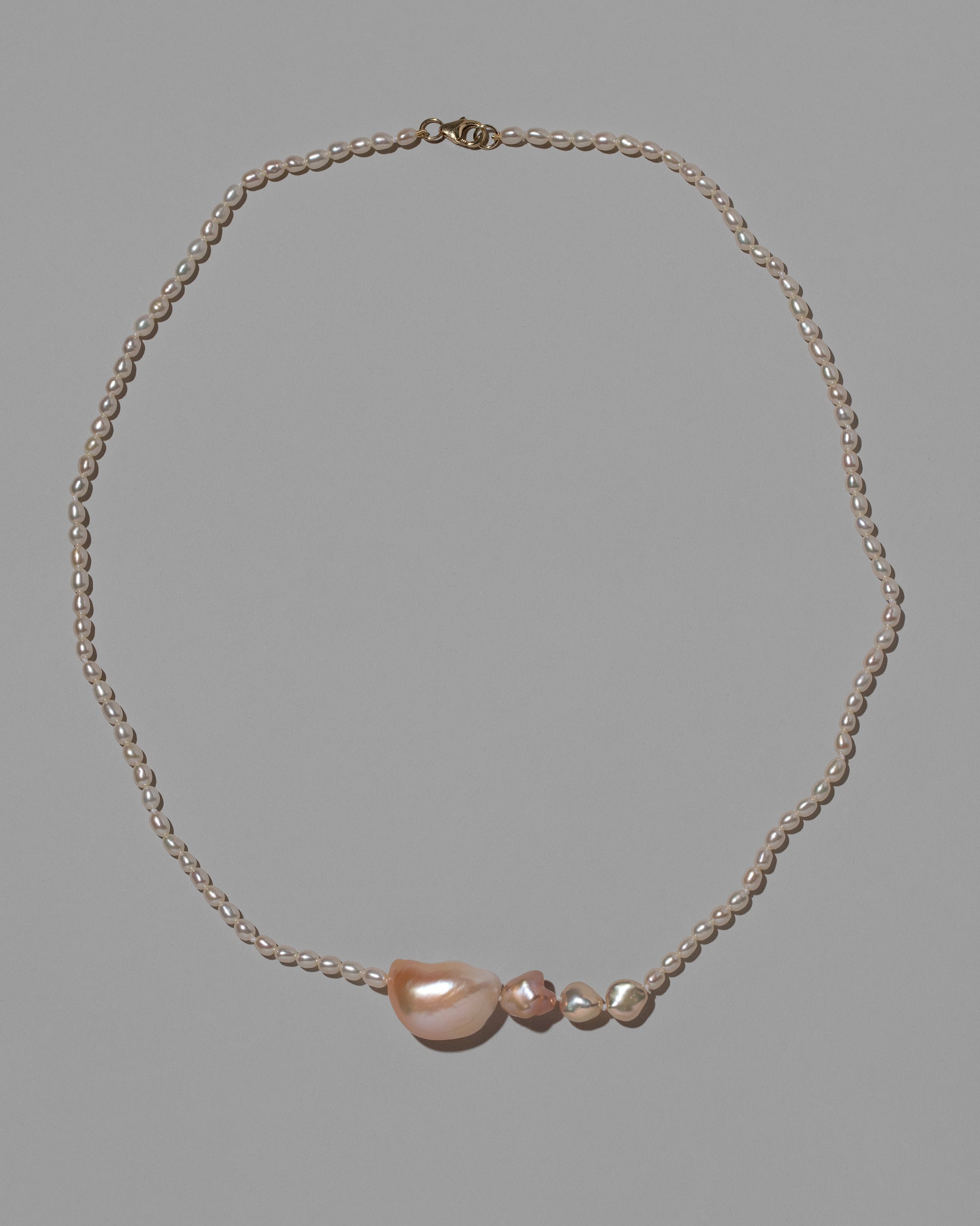 Tethys Pearl Necklace on light color background.