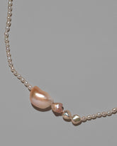 Tethys Pearl Necklace on light color background.