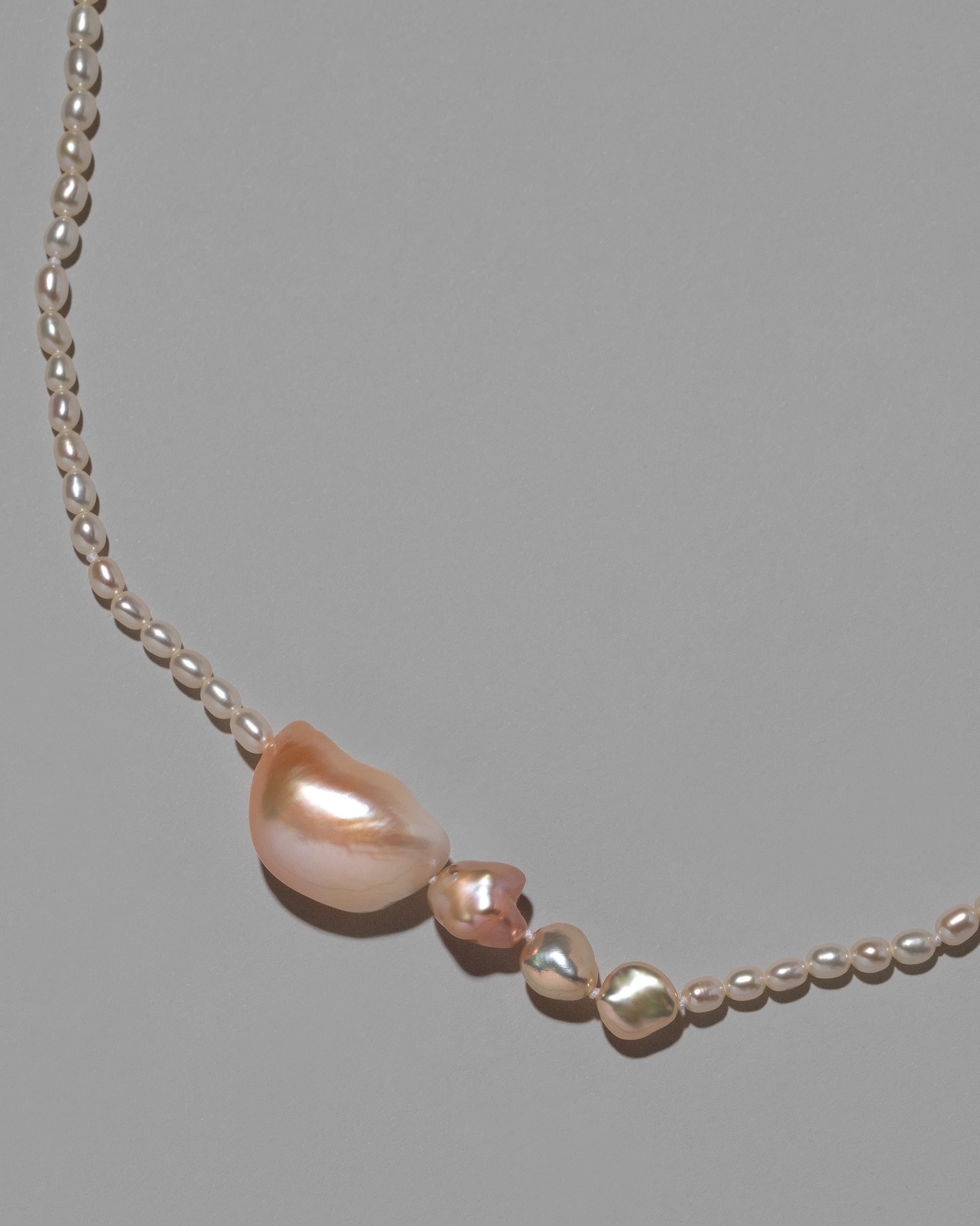 Tethys Pearl Necklace on light color background.