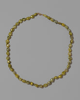 Brizo Necklace on light color background.